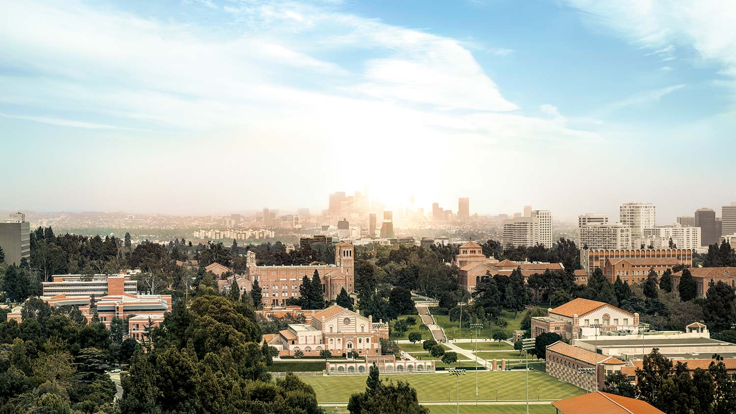 UCLA campus from above during daytime with the cityscape of LA at the horizon.