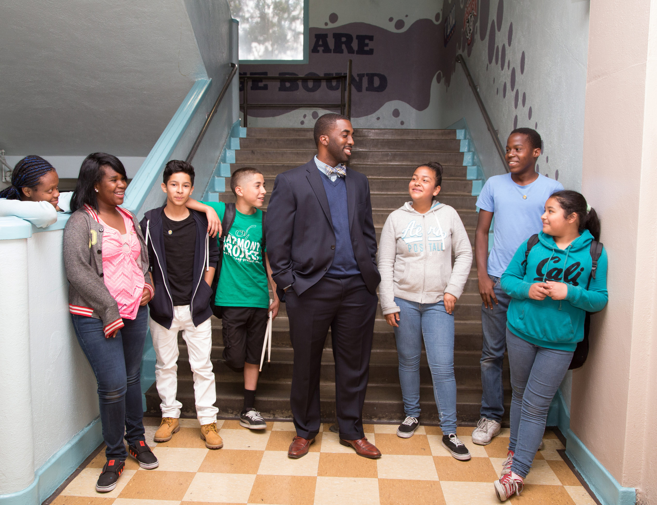School principal with students by staircase